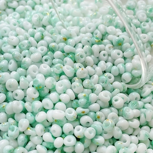 Macro shot of 4mm mint green marble glass beads with gold foil for DIY jewelry making