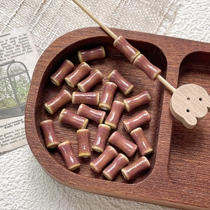 Detail of vintage purple bamboo-shaped ceramic beads with speckled texture for DIY jewelry