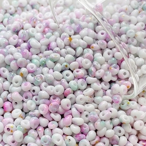 Macro view of 4mm cream marble glass beads with gold glitter for DIY jewelry making