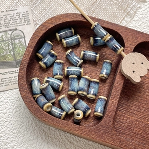 Macro detail of blue kiln-glazed ceramic bamboo tube beads for DIY jewelry making