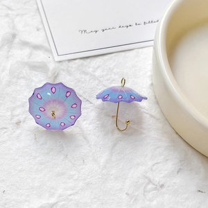 Detailed view of resin umbrella charms with blue purple gradient and golden hooks