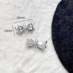 Vue détaillée du pendentif nœud papillon en métal argenté avec deux anneaux de 20x10mm