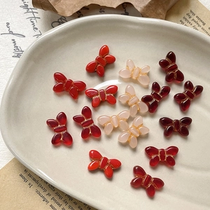 Detailed view of red vintage butterfly Czech glass beads for DIY jewelry making