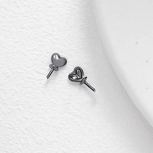 Macro view of gun black heart-shaped metal jewelry pin parts for DIY earring making