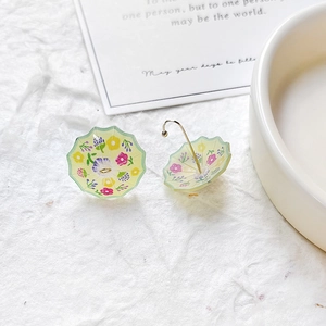 Close-up of mini umbrella pendants with floral prints and golden metal hooks