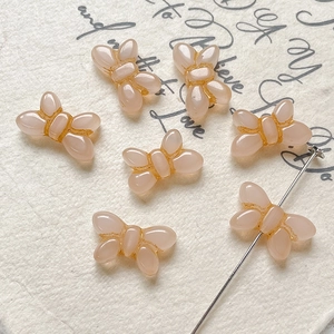 Macro view of butterfly Czech glass beads in vintage red with golden edges for jewelry DIY