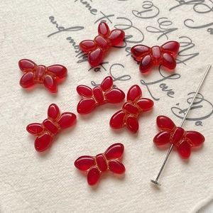 Macro shot of vintage red butterfly glass beads for DIY jewelry making and necklace crafts