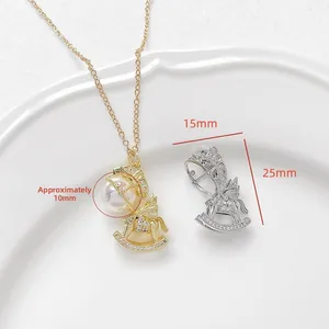 Detailed view of rocking horse pendants with gold plating and cubic zirconia inlay