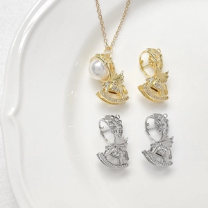 Detail of gold rocking horse pendant with pearls and cubic zirconia stones