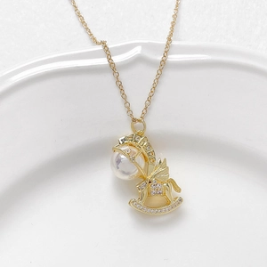 Gold plated rocking horse pendant with iridescent pearl and sparkling cubic zirconia