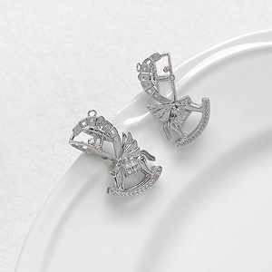 Macro detail of silver plated carousel horse pendants with sparkling cubic zirconia