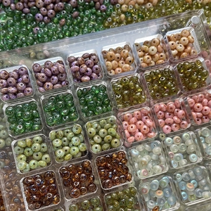 Czech glass rondelle beads in various colors organized in a clear acrylic storage box