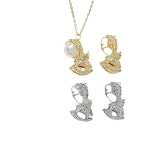 Gold plated rocking horse pendant with cubic zirconia and pearls on white background
