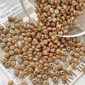 Macro shot of discoid Czech glass beads with marble texture for DIY jewelry making