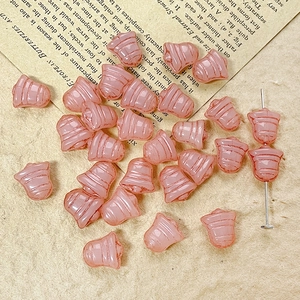 Macro view of pink bell-shaped frosted glass beads for DIY vintage jewelry making