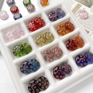 Close-up of hand-painted sun and moon Czech glass beads for DIY jewelry making