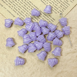 Close-up of purple bell-shaped Czech glass beads with white stripes for DIY jewelry making