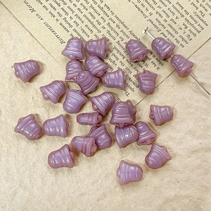 Detailed view of lavender bell-shaped Czech glass beads for DIY jewelry making