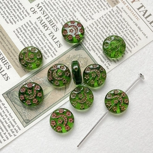 Detailed macro view of green glass moon and star beads for DIY jewelry making and crafting
