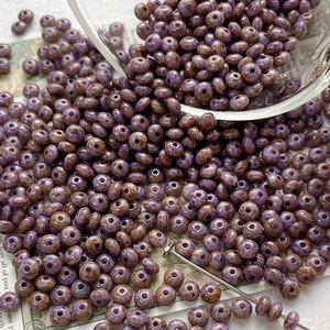 Macro shot of purple and brown marble textured glass beads for DIY jewelry making