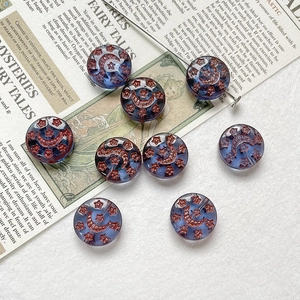 Detail of vintage hand-painted star and moon Czech glass beads for DIY jewelry making