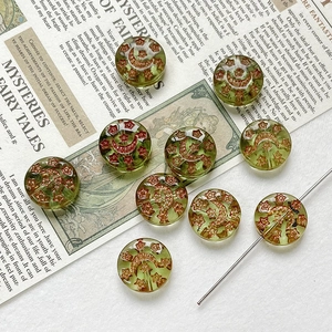 Detail of translucent olive green moon and star beads for DIY jewelry making