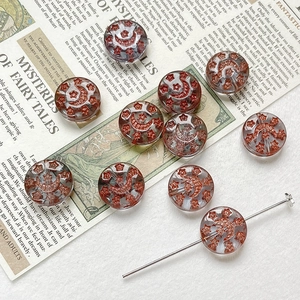 Detail of vintage glass beads with red glitter star and moon motifs for DIY jewelry