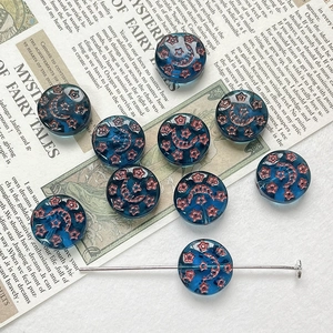 Detail of blue Czech glass beads with star and moon motifs for DIY jewelry making