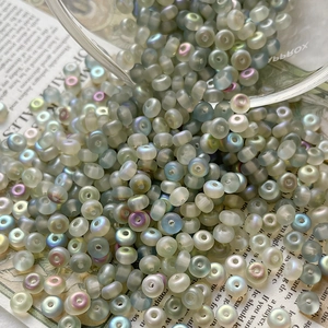 Macro shot of iridescent frosted Czech glass beads for DIY jewelry and embroidery