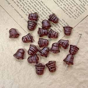 Macro view of vintage bell-shaped Czech glass beads in deep purple for DIY jewelry making