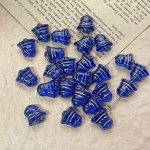 Close-up of blue bell-shaped Czech glass beads with gold stripes for DIY jewelry making