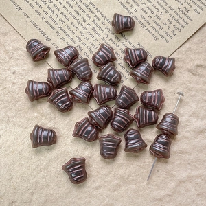Macro view of vintage bronze-tone bell-shaped Czech glass beads for DIY jewelry making