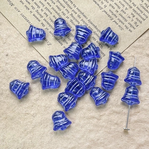 Macro detail of blue Czech glass bell beads with silver stripes for DIY jewelry making