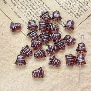 Macro shot of dark red vintage bell-shaped Czech glass beads for DIY jewelry making