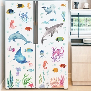 Watercolor sea animal wall stickers with shark and dolphin motifs on white fridge