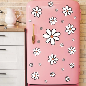 Boho daisy wall stickers featuring white petals and orange centers on a pink fridge