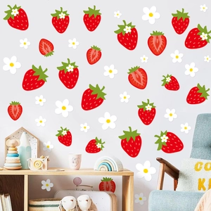 Detail of vibrant red strawberry wall decals and white blossoms on a grey interior wall