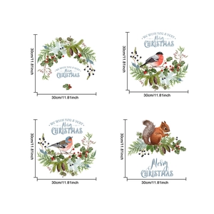 Detail of Christmas wall stickers featuring squirrels, birds, and red berries on a white background