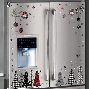 Watercolor Christmas refrigerator stickers with trees and snowflakes on a metal fridge