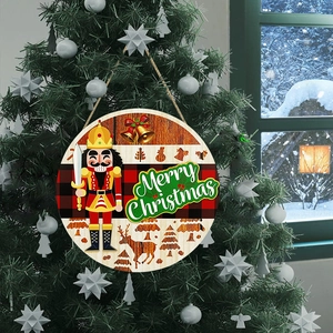 Wooden round Christmas door sign with nutcracker and red plaid pattern on a tree