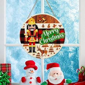 Round wooden Nutcracker Merry Christmas welcome sign hanging on a frosted window