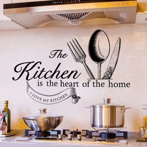 Black vinyl wall decal featuring Kitchen heart quote and utensil motifs in a modern kitchen