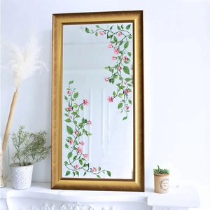 Rectangle gold frame mirror decorated with pink floral and green vine wall stickers