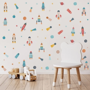 Cartoon space wall stickers featuring planets and rockets in a cozy nursery room