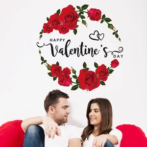 Detail of red rose wreath wall sticker with Happy Valentine's Day text on home interior wall