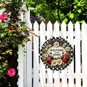 Spring round wooden welcome sign with ladybugs and daisy flowers on a white fence
