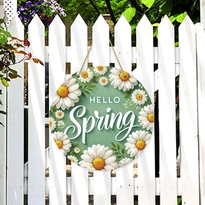 Round wooden door sign with Hello Spring text and daisies on a white garden fence
