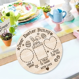 Detail of round wooden Easter tray with bunny engravings and specific snack placement sections