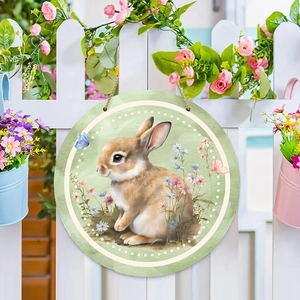 Round wooden Easter welcome sign with bunny and floral design on white garden fence