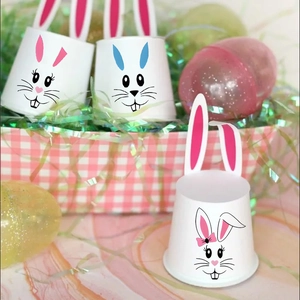 Close-up of Easter paper cups with bunny ears and cute faces for festive party decor
